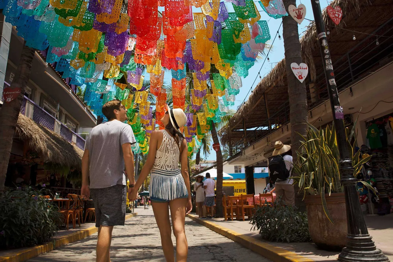 couple exploring Sayulita with festive colors