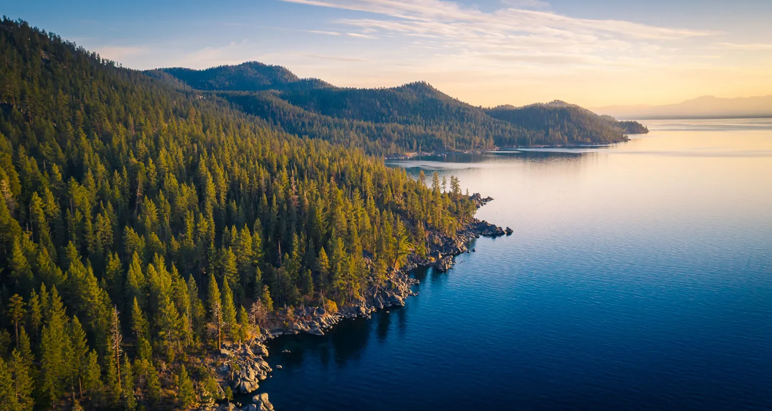 Aerial view of the mountains & forest at Lake Tahoe.