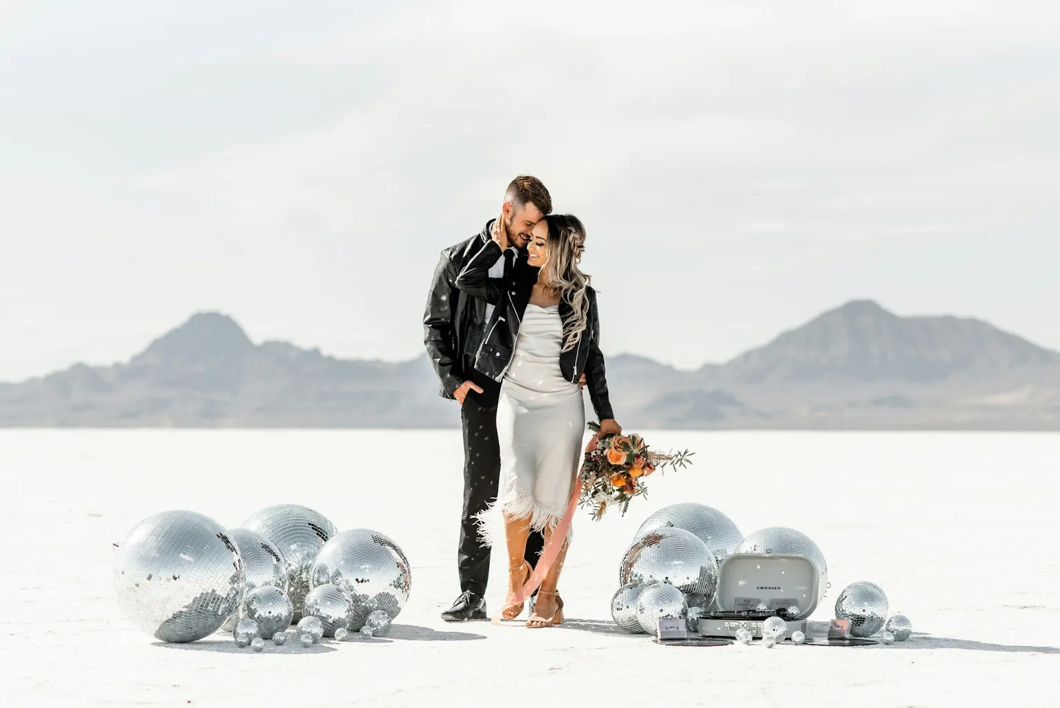 A couple standing in the middle of the desert