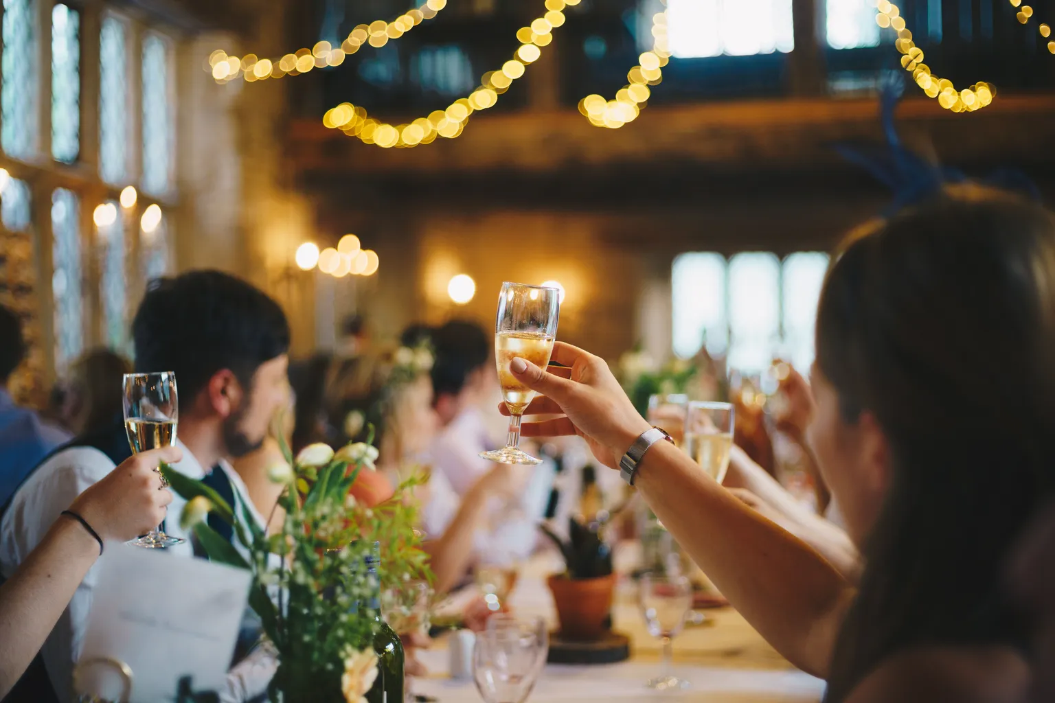 people toasting their glasses at an event