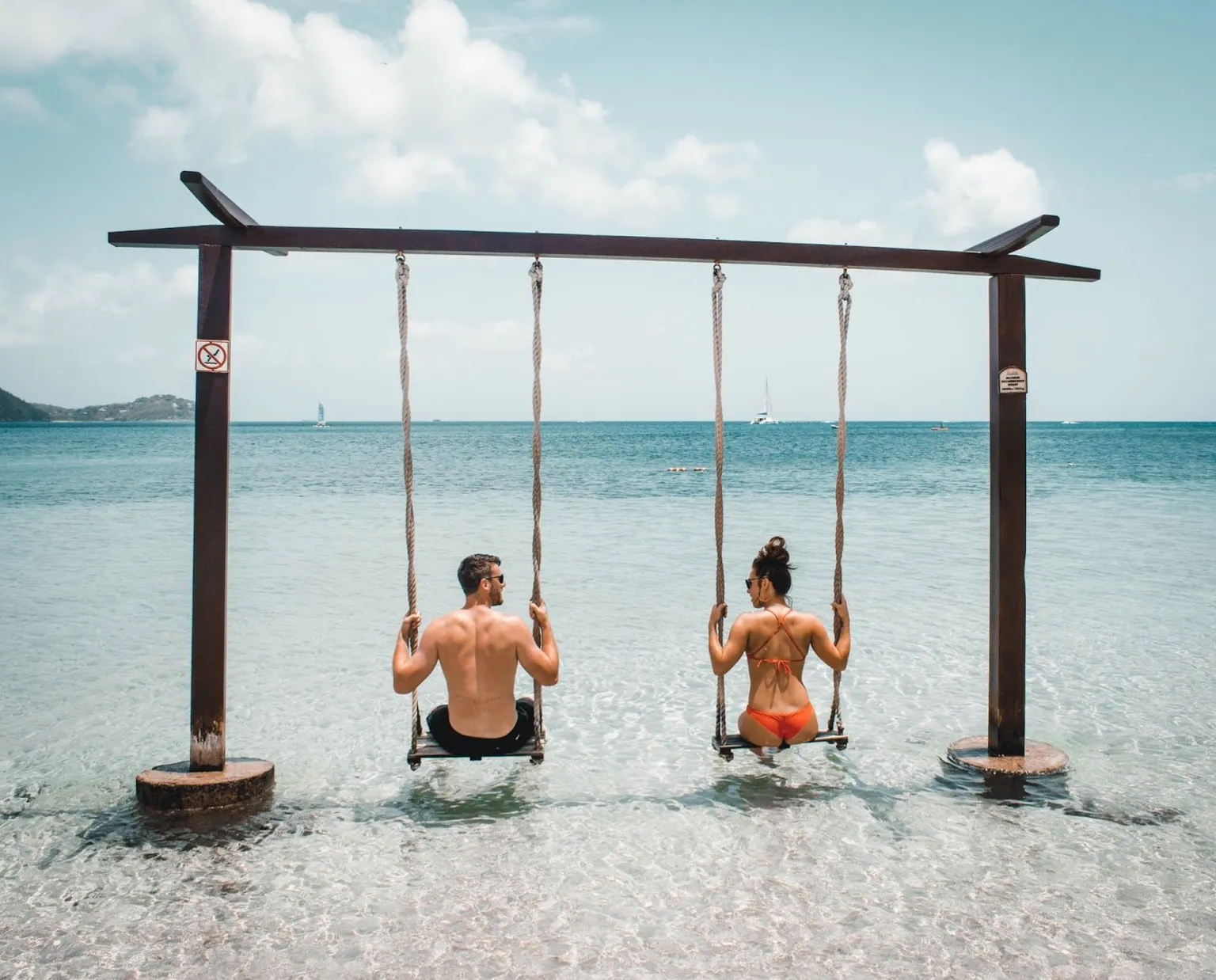 couple swinging on the beach