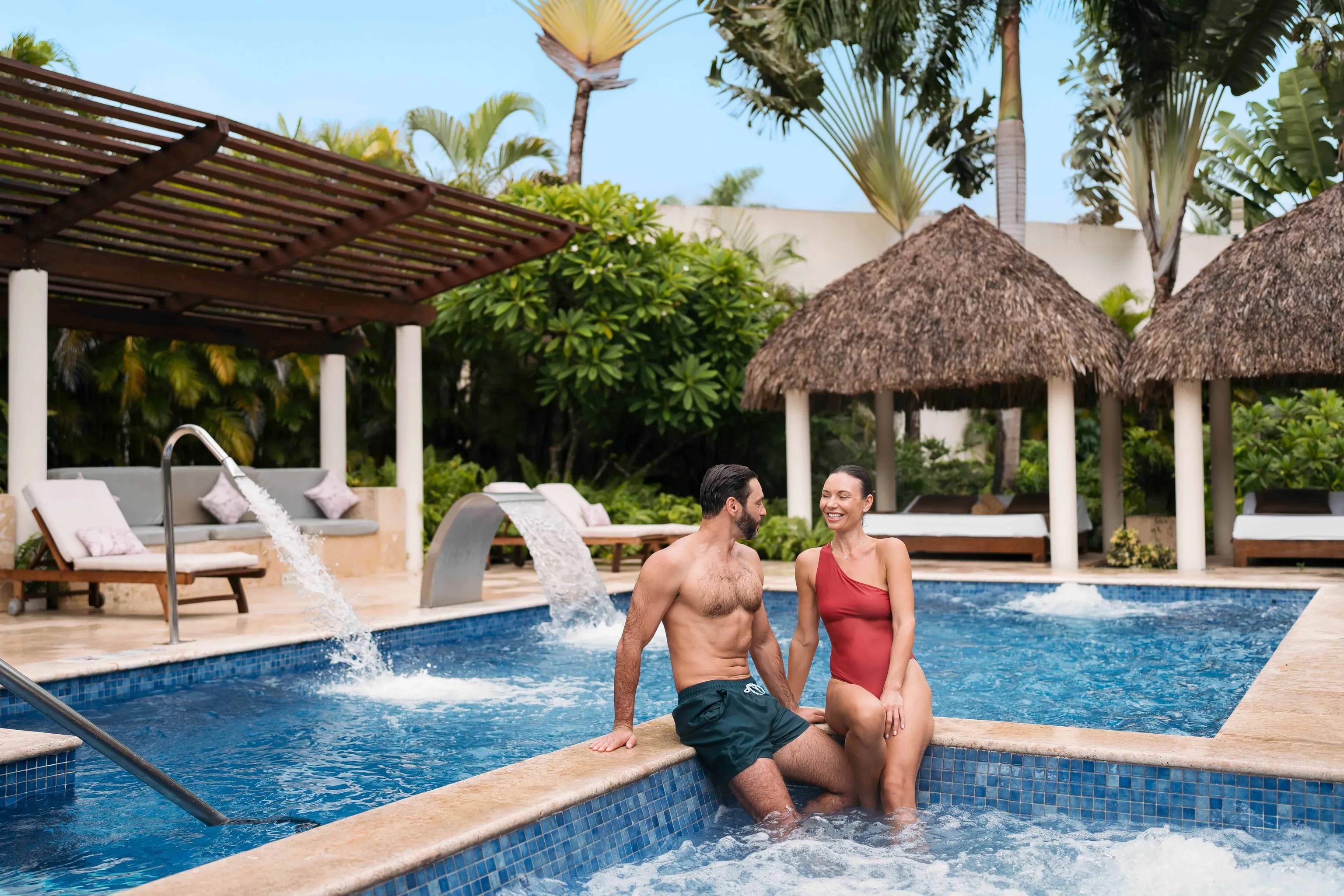 Couple hanging beside a pool