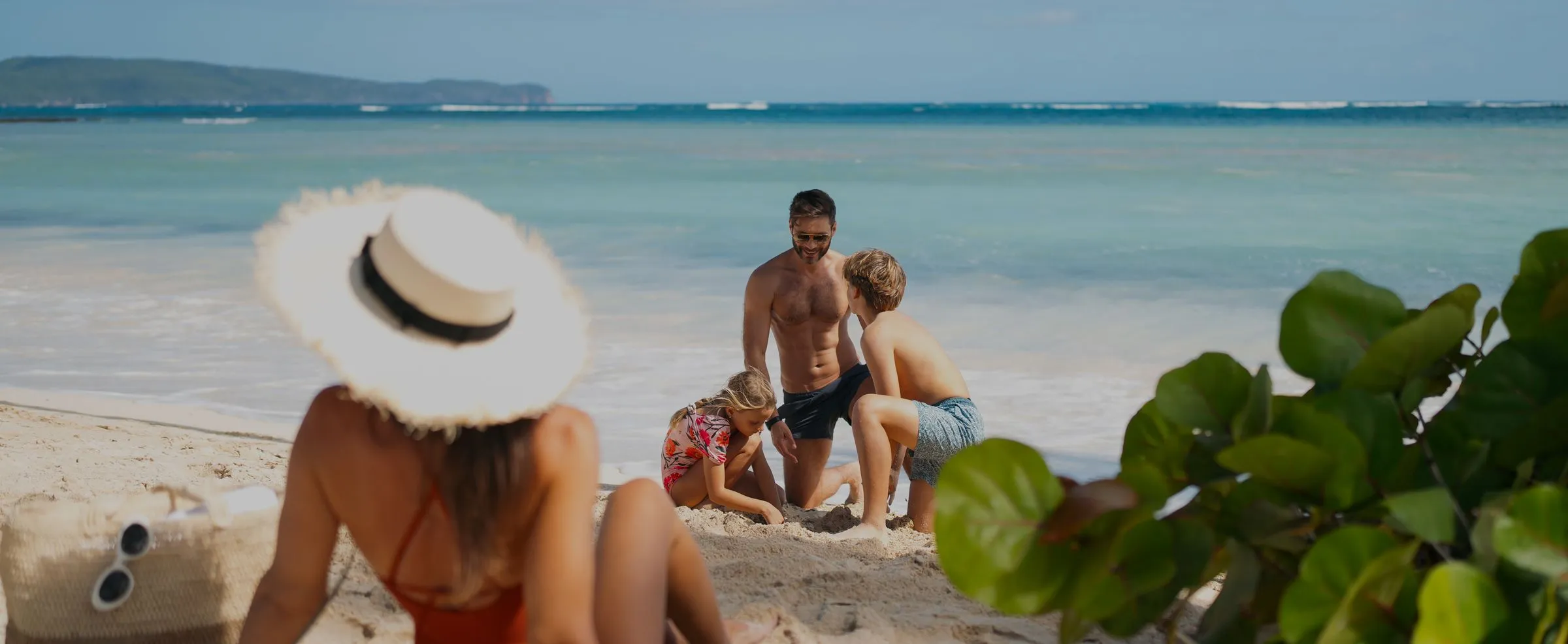 Family enjoying quality time building sandcastles on a scenic beach at a Caribbean resort