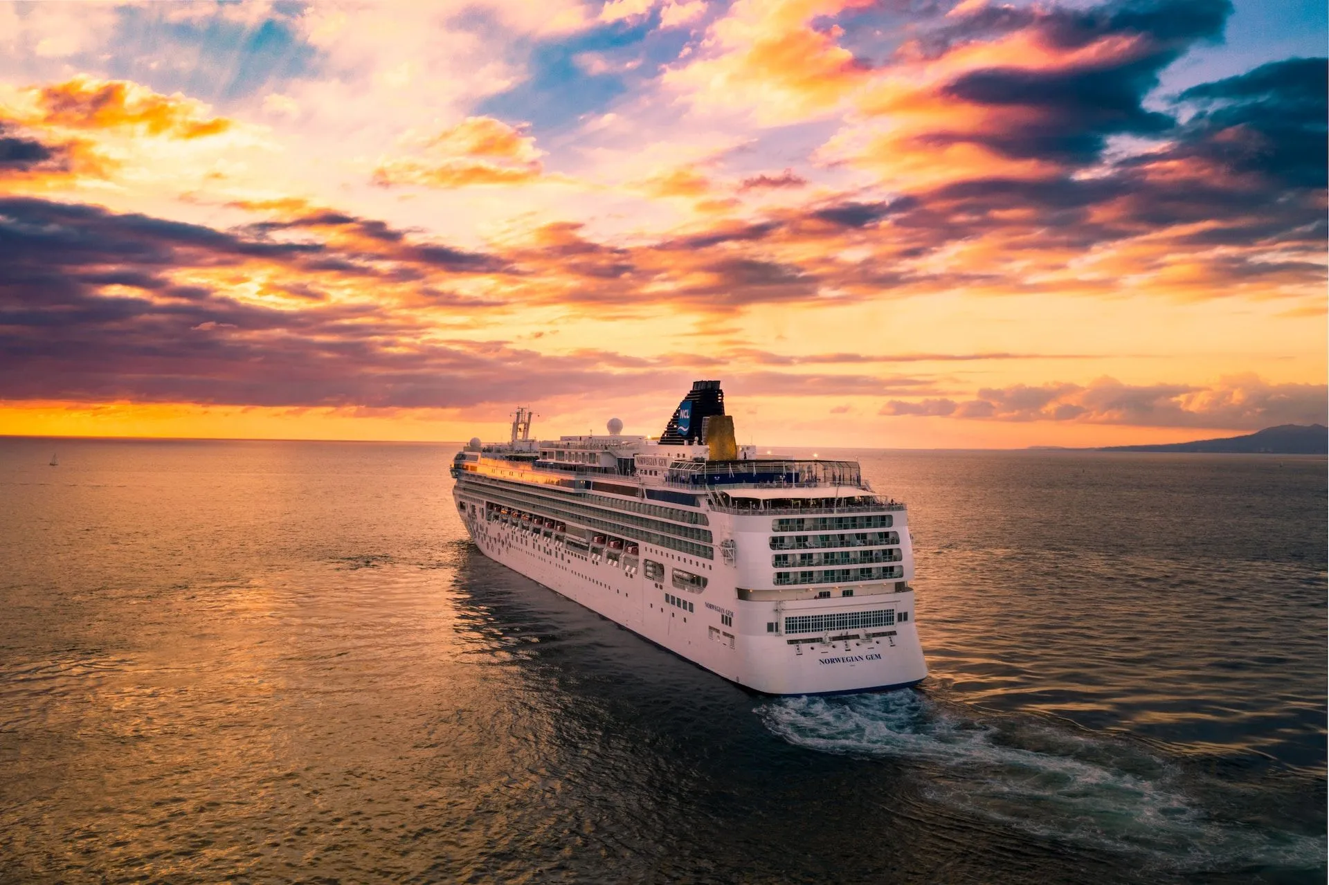 cruise ship drifting into sunset