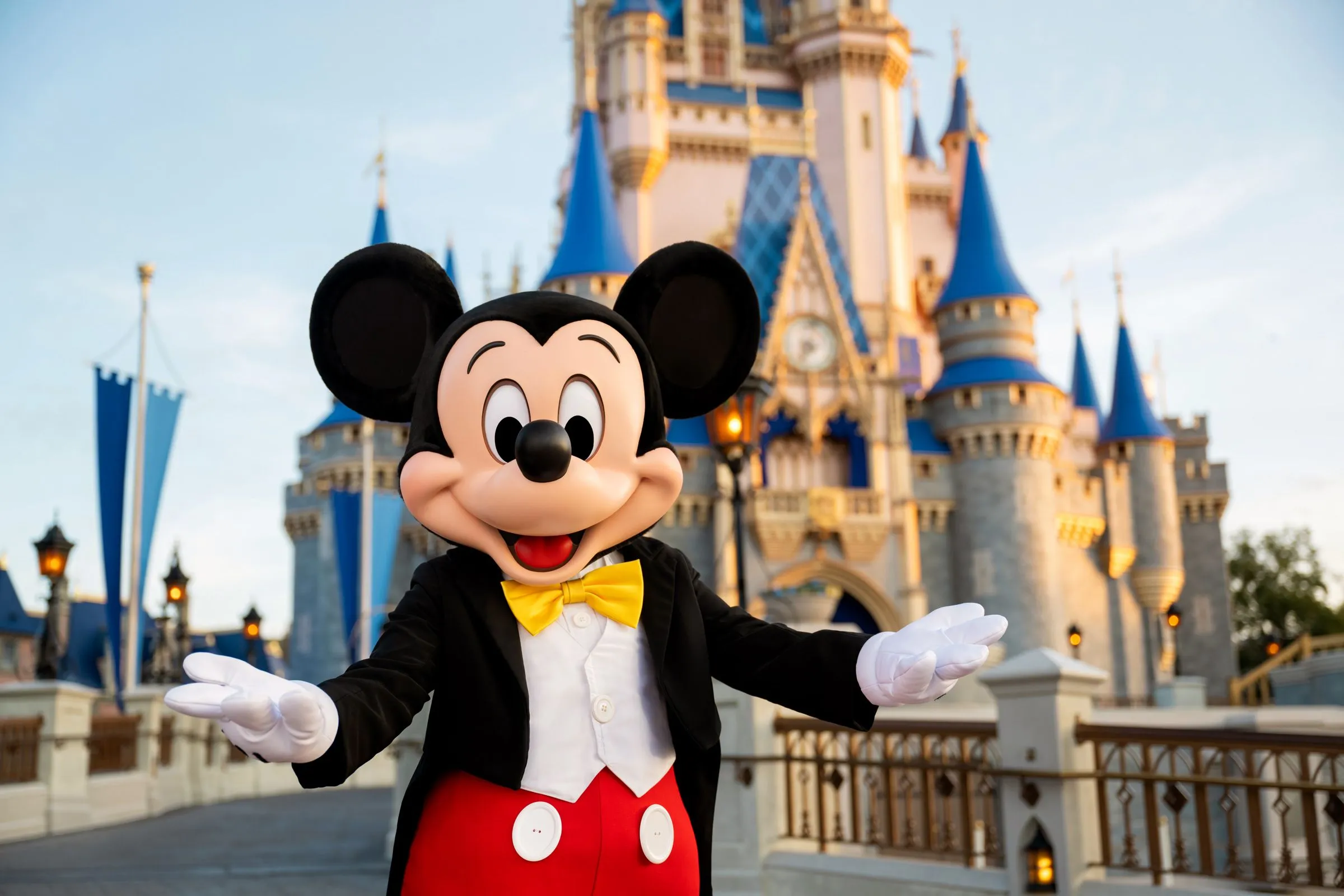 Mickey Mouse greeting guests in front of Cinderella Castle at Walt Disney World