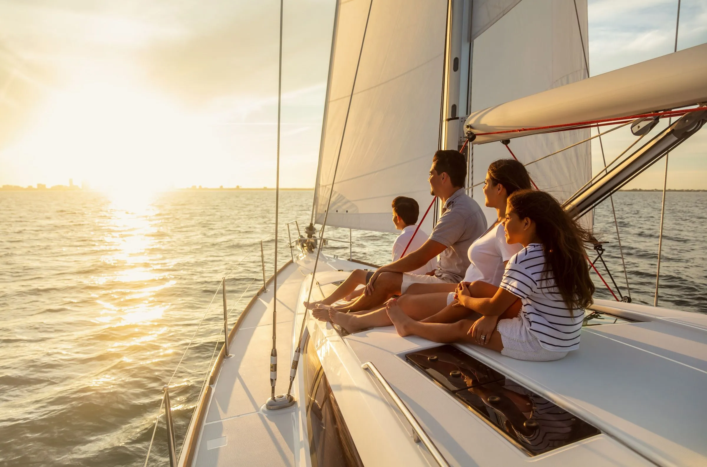 Family sailing at sunset.