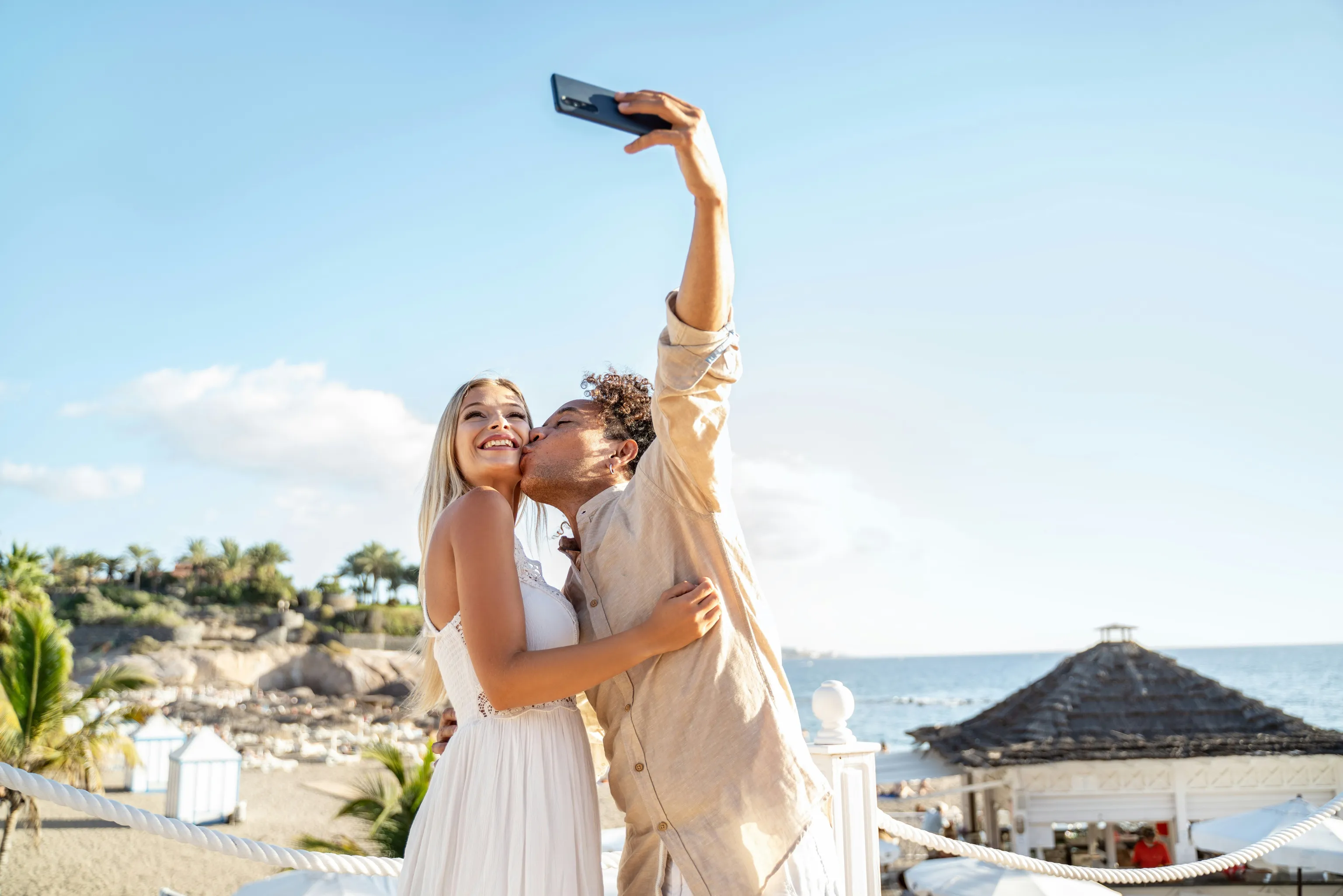 couple kissing and taking a selfie