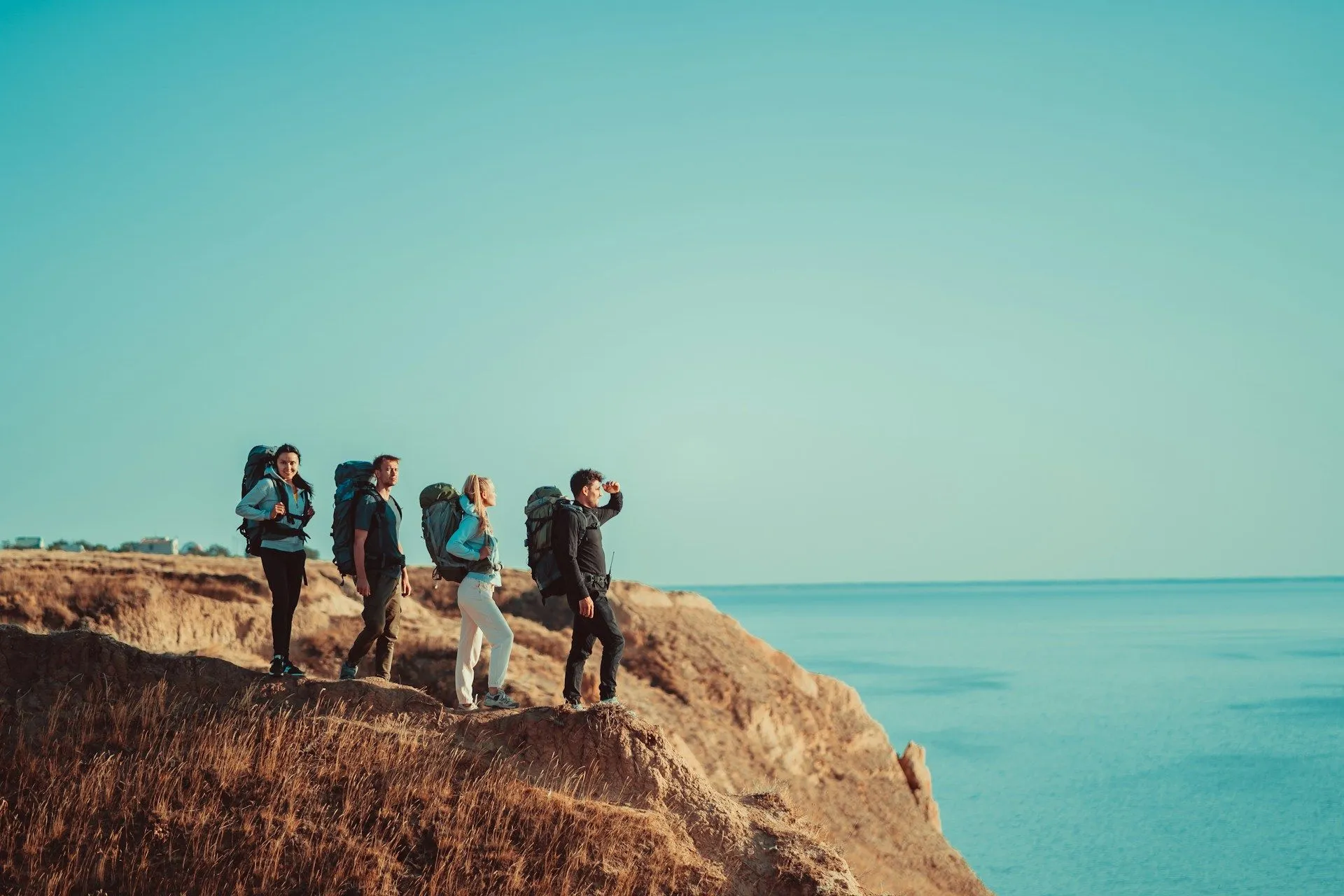 Group of friends hiking along coastal cliffs.