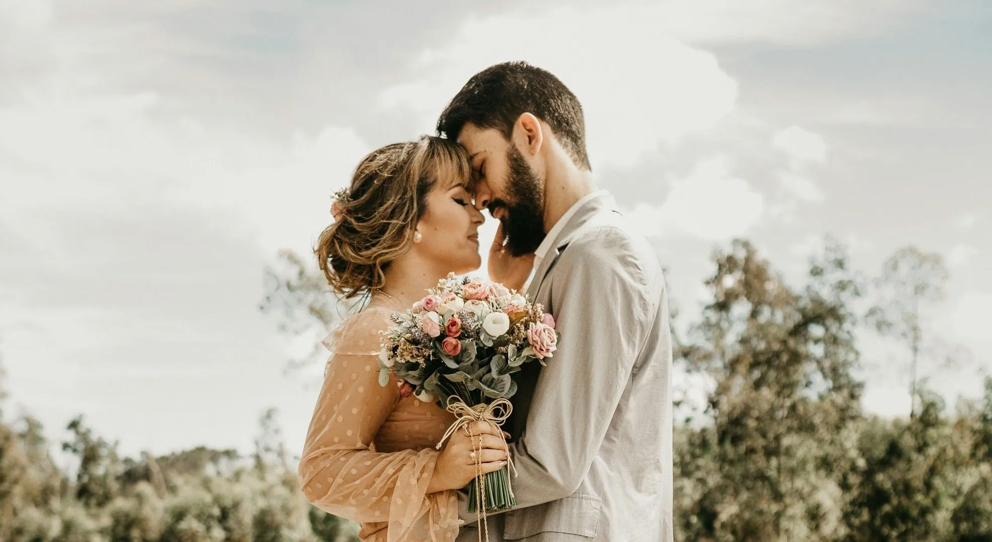 couple embracing on a dock with woman holding flowers