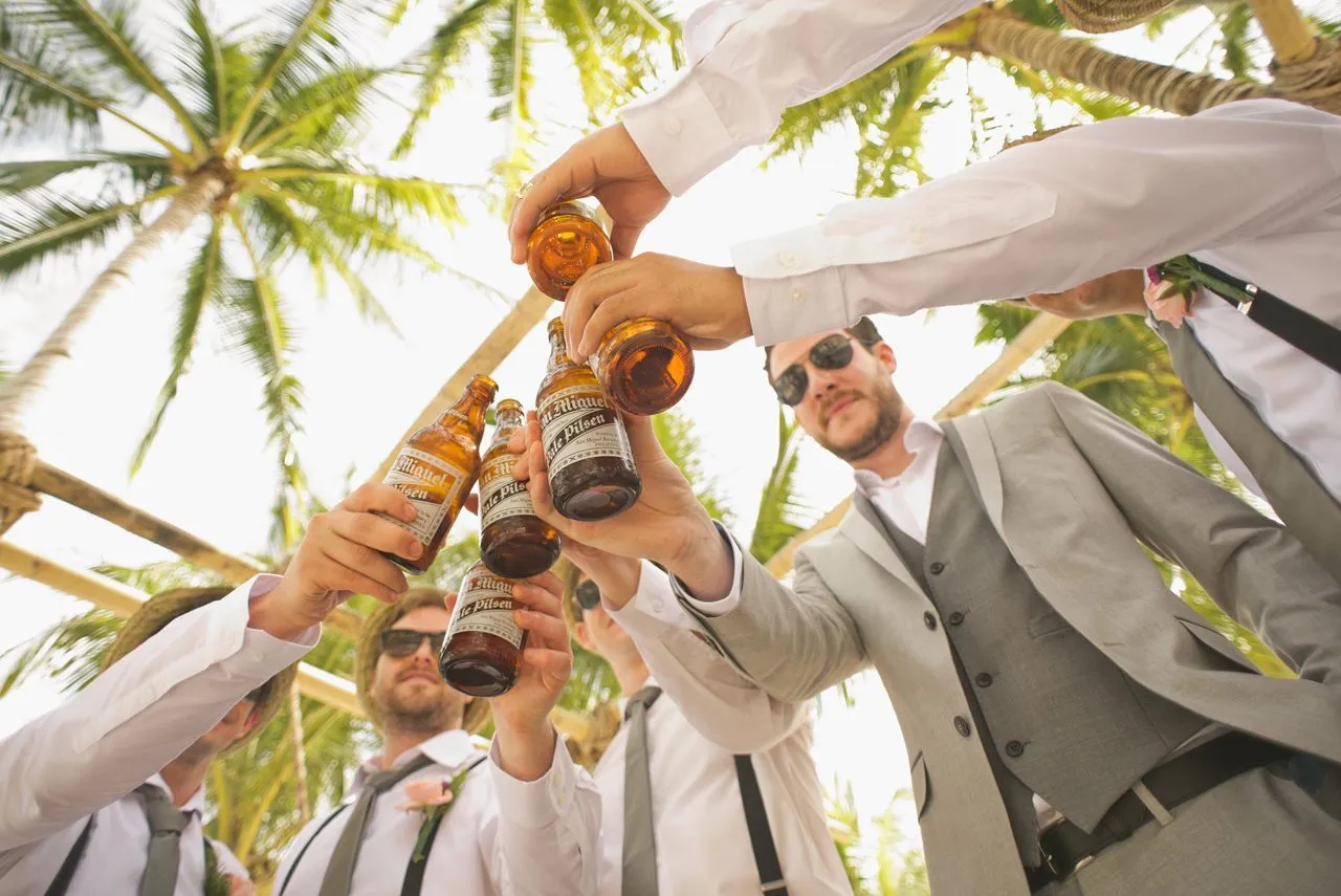 groom and groomsmen sitting on stairs with view from the neck down