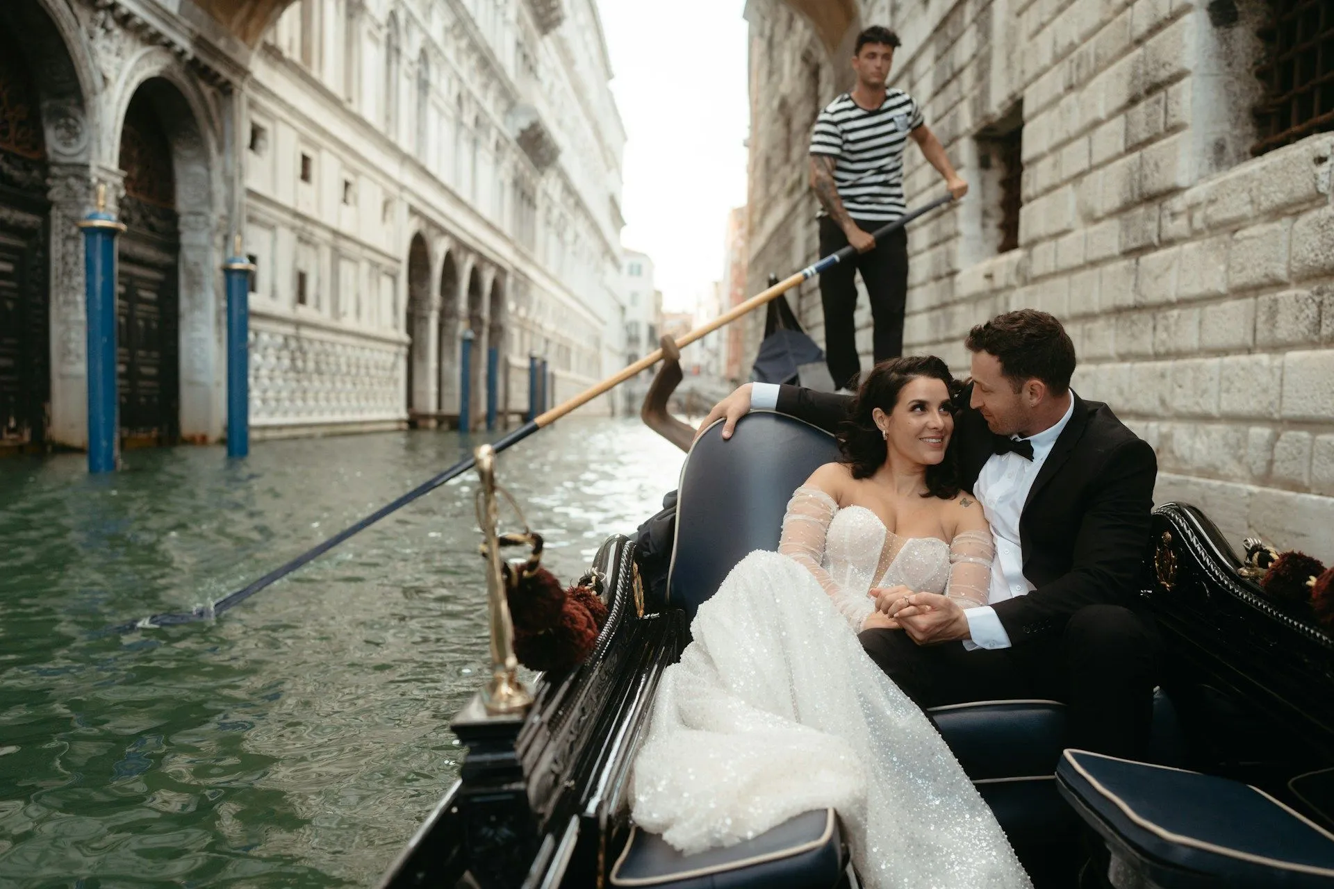 Bride and groom in a river ride through the Venice canals.