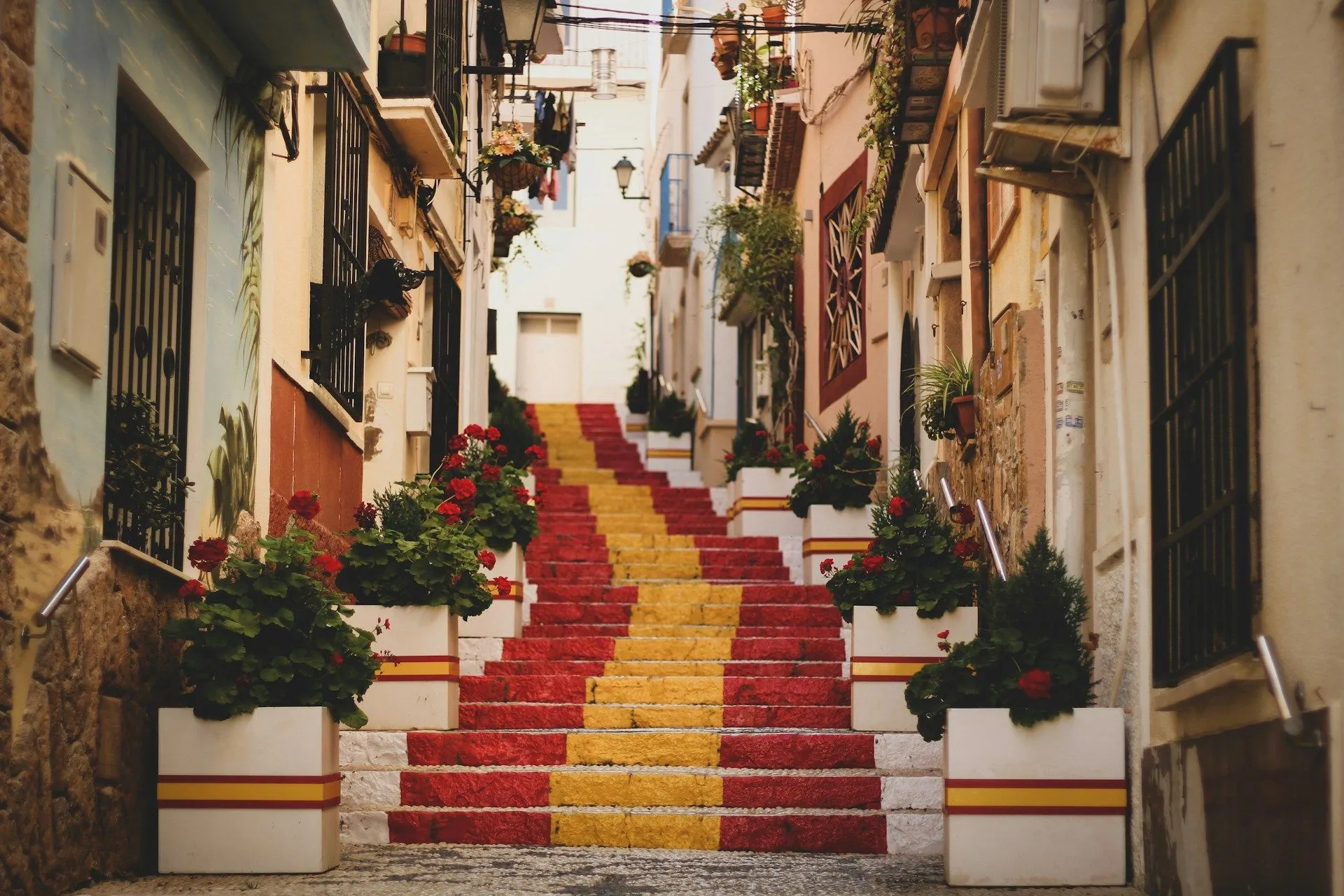 Colorful red and yellow staircase in a narrow Spanish old town street